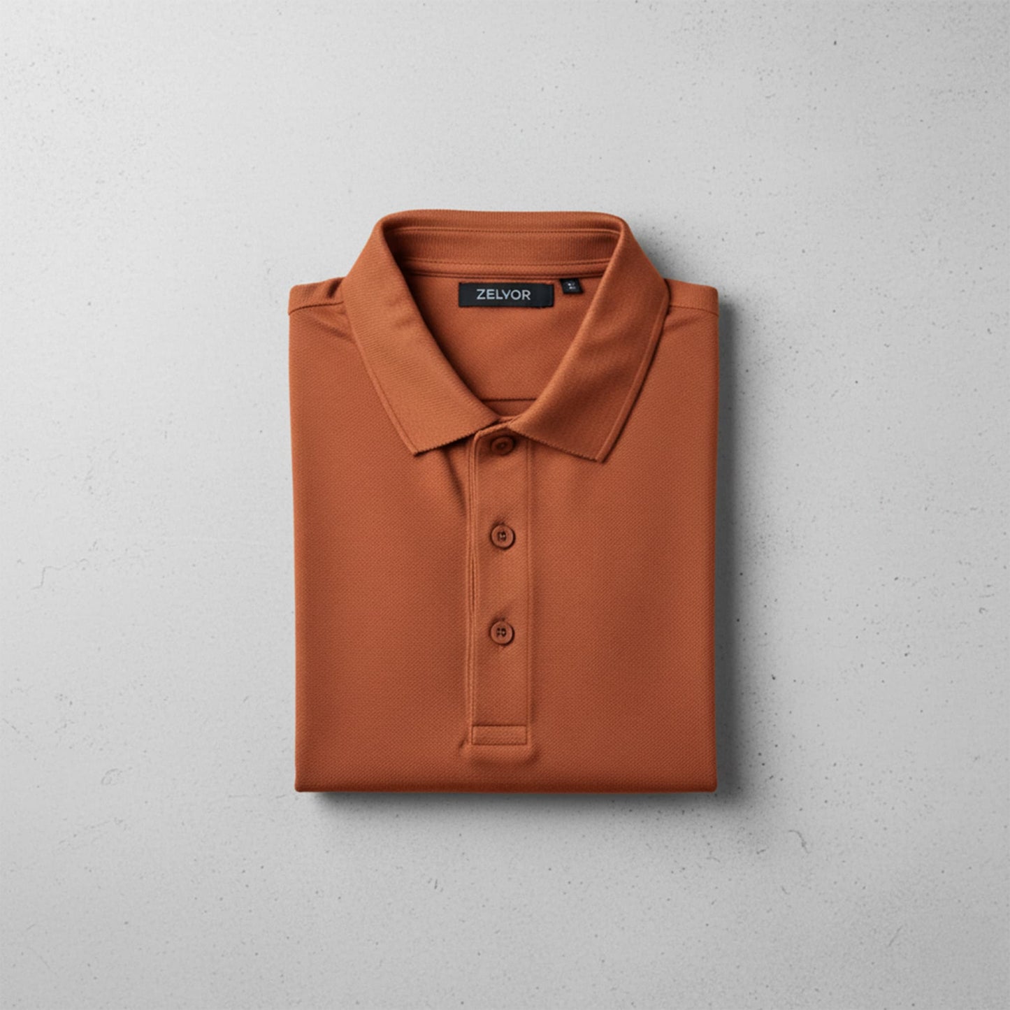 Chomba ZELVOR Essential Piqué – Rojo Terracota